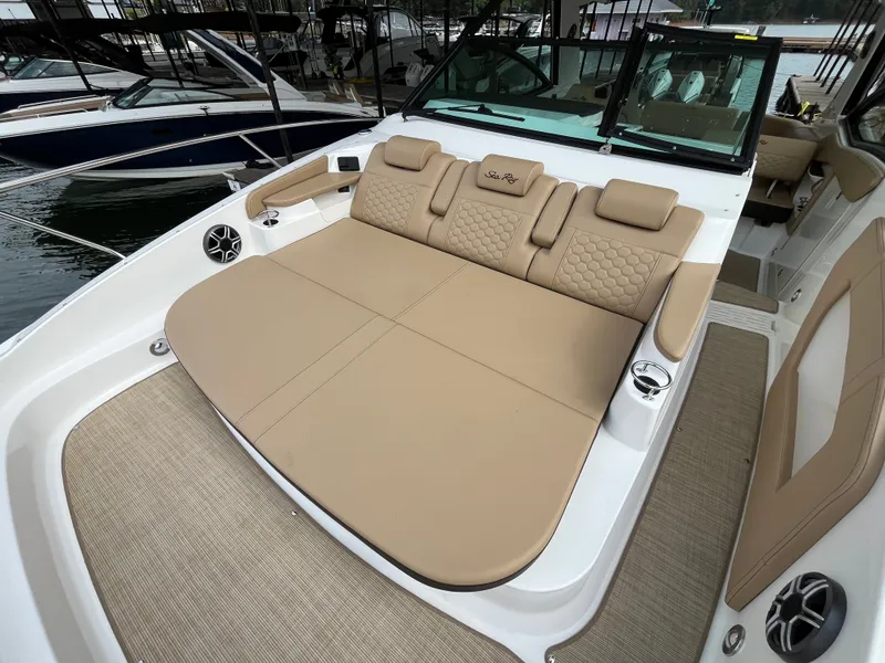 Slide: The Image of The image shows the spacious sun deck of a 2026 Sea Ray Sundancer 320. - 15