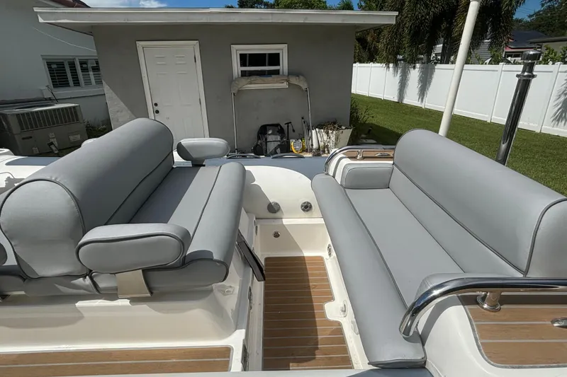 Slide: The Image of 2019 Williams Jet Tenders Dieseljet 505 with gray seating, parked near a small building. - 9