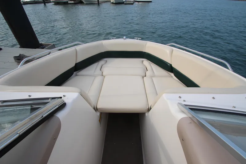 Slide: The Image of 1999 Bryant 182 boat with spacious seating, docked by the water. - 11