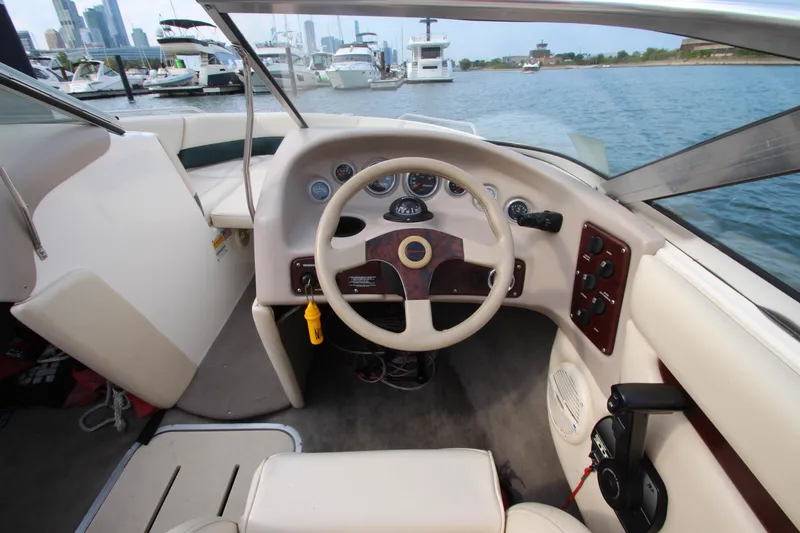 Slide: The Image of Interior of a 1999 Bryant 182 boat with steering wheel and dashboard controls. - 12