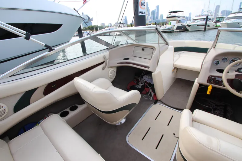 Slide: The Image of Interior of a 1999 Bryant 182 boat with beige seating and dashboard. - 14