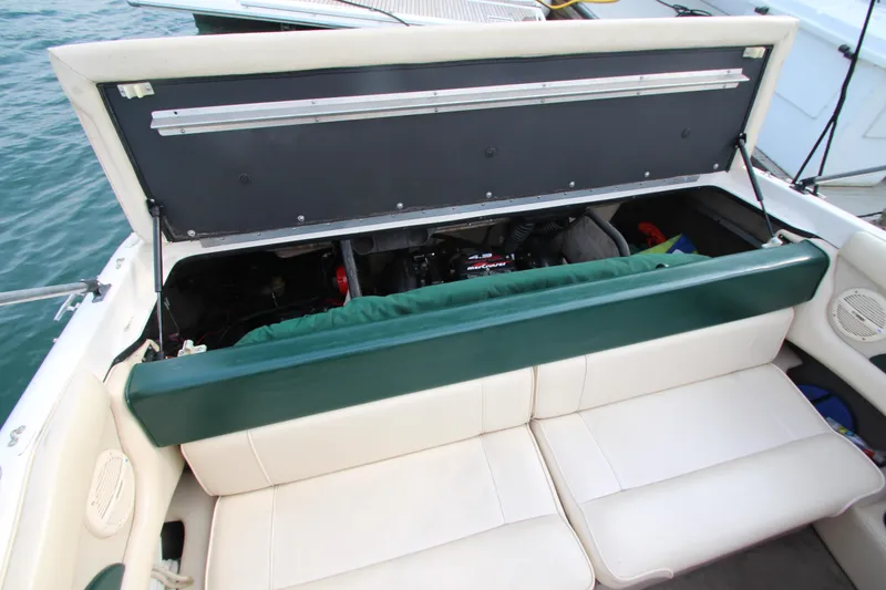 Slide: The Image of Open engine compartment of 1999 Bryant 182 boat with white seating. - 18