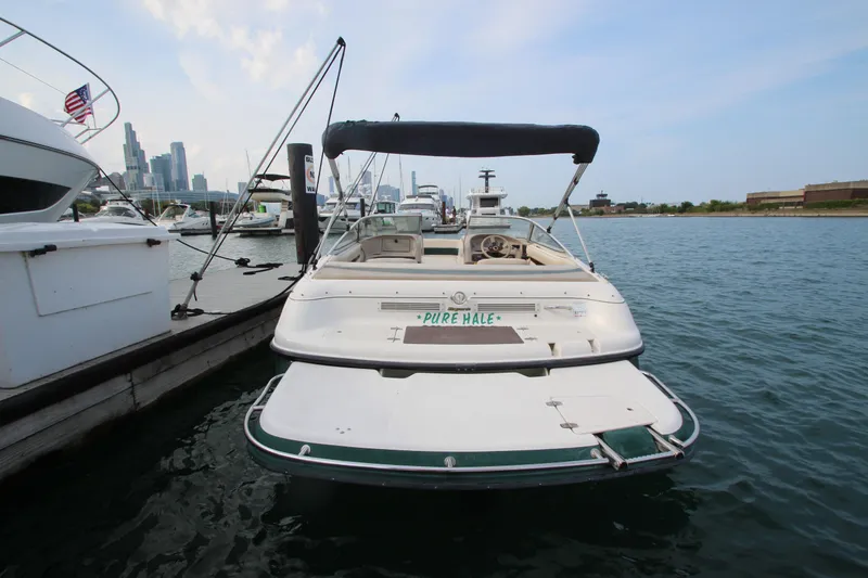 Slide: The Image of 1999 Bryant 182 boat docked in marina with city skyline in background. - 3
