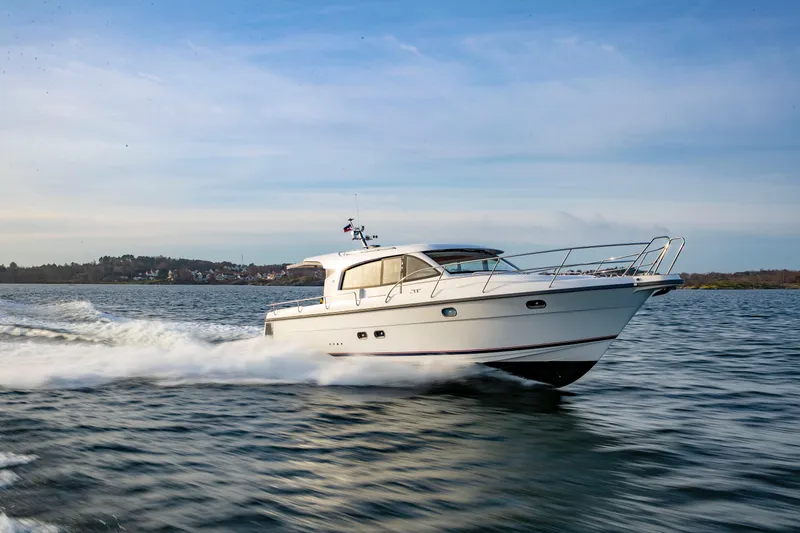 The Image of 2026 Nimbus 405 Coupé cruising on open water under a clear blue sky. - 0