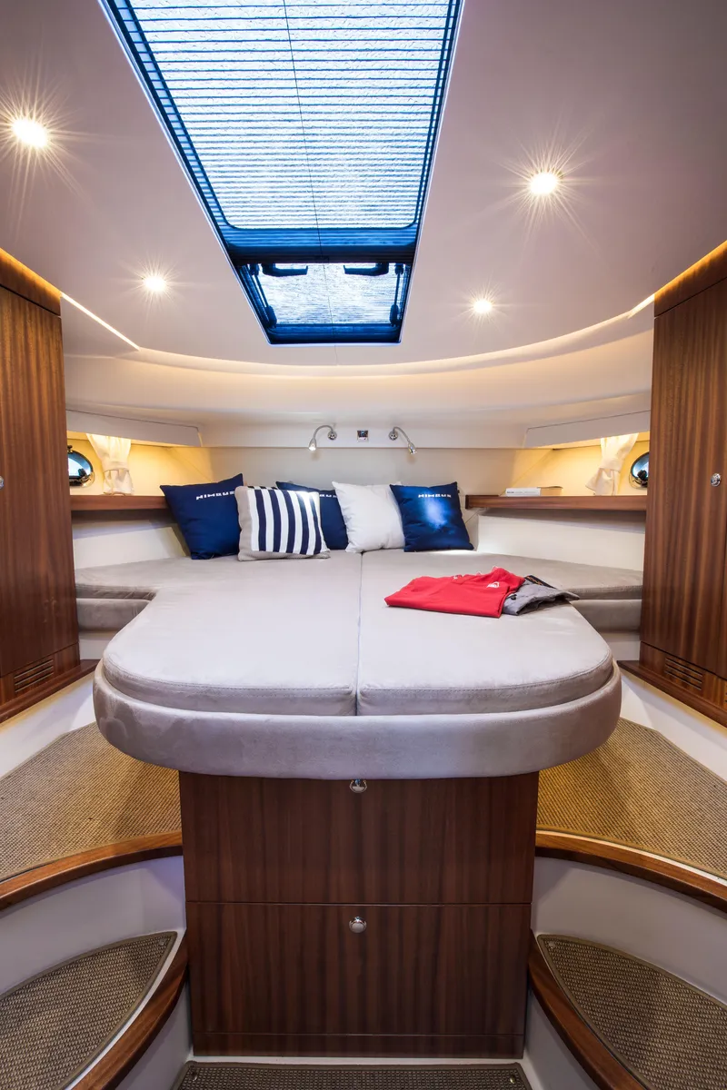 Slide: The Image of Luxurious interior of 2026 Nimbus 405 Coupé yacht with elegant wood finishes and skylight. - 7