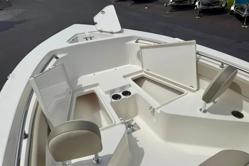 Slide: The Image of 2022 Key West 203 FS boat interior with open storage compartments and seating. - 12