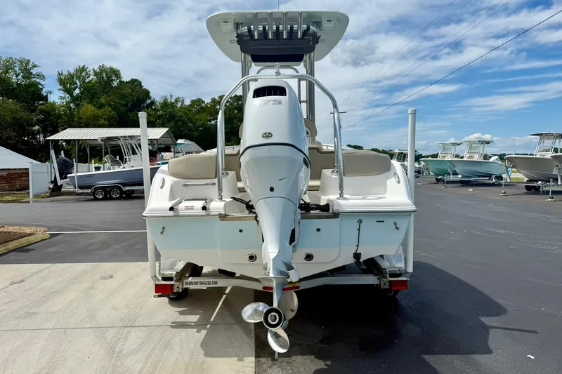 Slide: The Image of 2022 Key West 203 FS boat, rear view, parked on a trailer under a clear sky. - 2