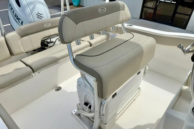 Slide: The Image of 2022 Key West 203 FS boat interior with beige seating and Suzuki engine. - 22