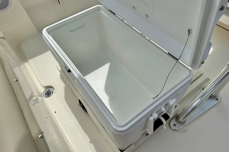 Slide: The Image of Open storage compartment on 2022 Key West 203 FS boat, featuring a white interior. - 26