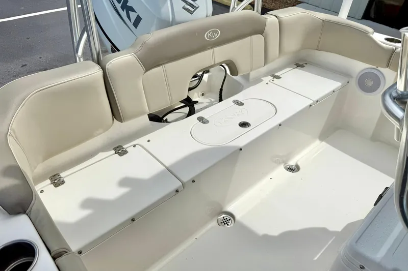 Slide: The Image of 2022 Key West 203 FS boat interior with beige seating and storage compartments. - 28