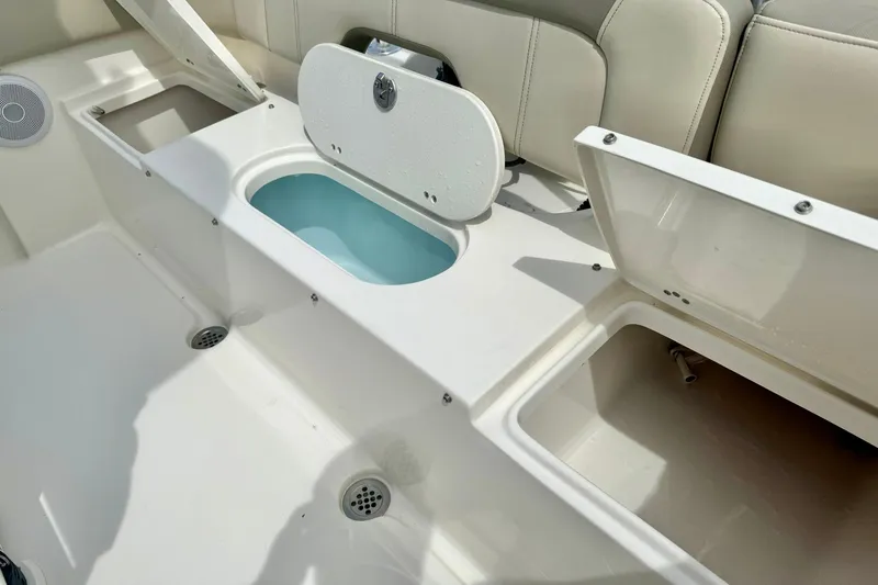 Slide: The Image of 2022 Key West 203 FS boat interior with open storage compartments and seating. - 29