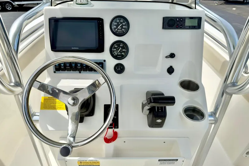 Slide: The Image of 2022 Key West 203 FS boat dashboard with steering wheel, gauges, and controls. - 3