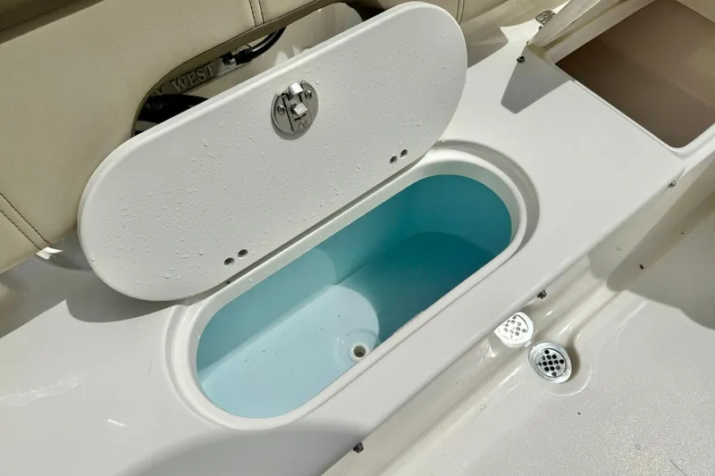 Slide: The Image of Livewell compartment on 2022 Key West 203 FS boat, featuring a white and blue interior. - 30