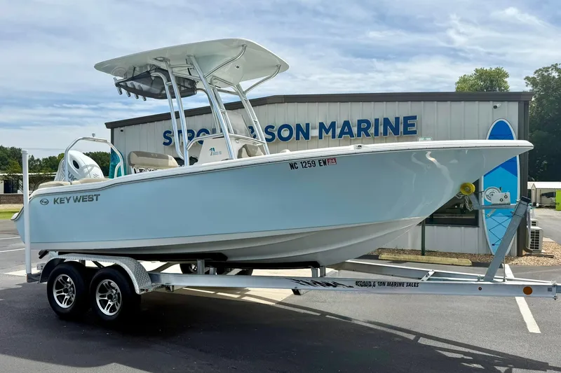 Slide: The Image of 2022 Key West 203 FS boat on trailer outside a marine dealership. - 4