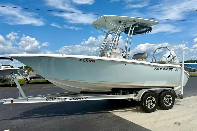 Slide: The Image of 2022 Key West 203 FS boat on trailer under blue sky. - 5