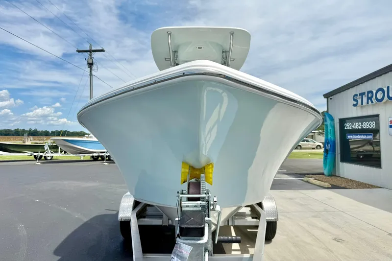 Slide: The Image of 2022 Key West 203 FS boat on trailer, parked outside dealership under clear sky. - 8