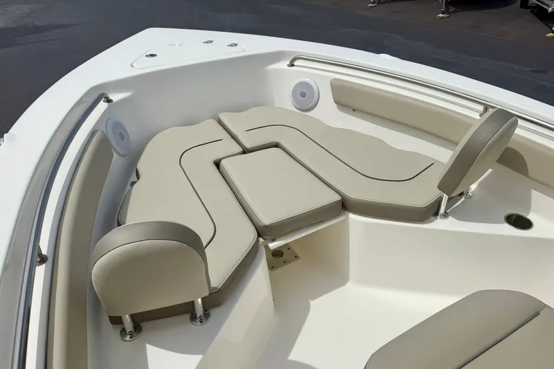 Slide: The Image of 2022 Key West 203 FS boat interior with beige cushioned seating and stainless steel railings. - 9