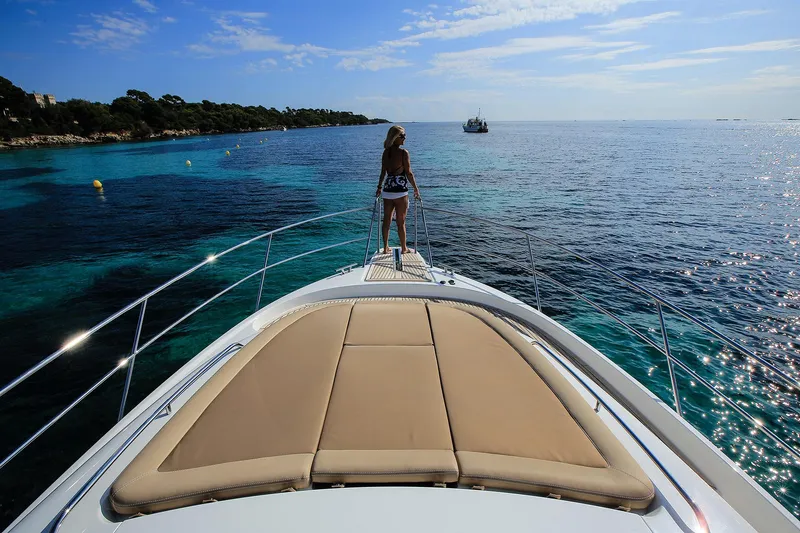 Slide: The Image of Woman on Nimbus 405 Flybridge yacht, 2025 model, enjoying scenic ocean view. - 6