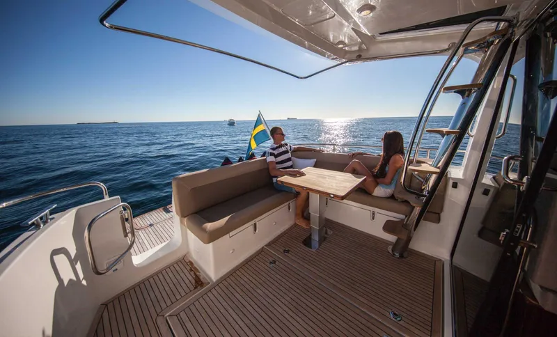 Slide: The Image of Couple relaxing on Nimbus 405 Flybridge yacht, 2025 model, enjoying ocean view. - 7
