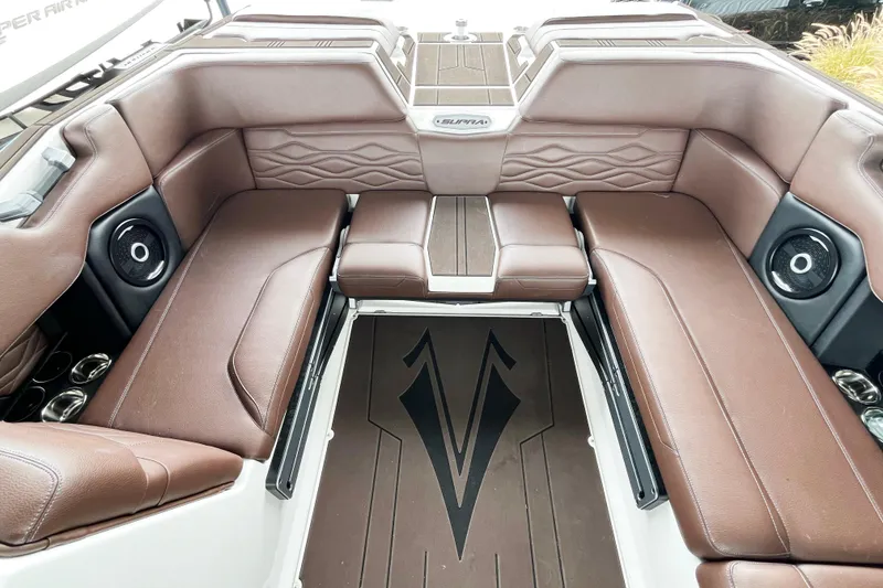 Slide: The Image of 2025 Supra SA450 boat interior with brown leather seating and integrated speakers. - 11