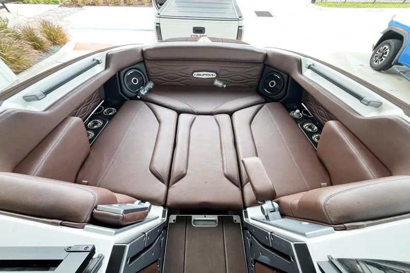 Slide: The Image of 2025 Supra SA450 boat interior with brown leather seating and built-in speakers. - 12