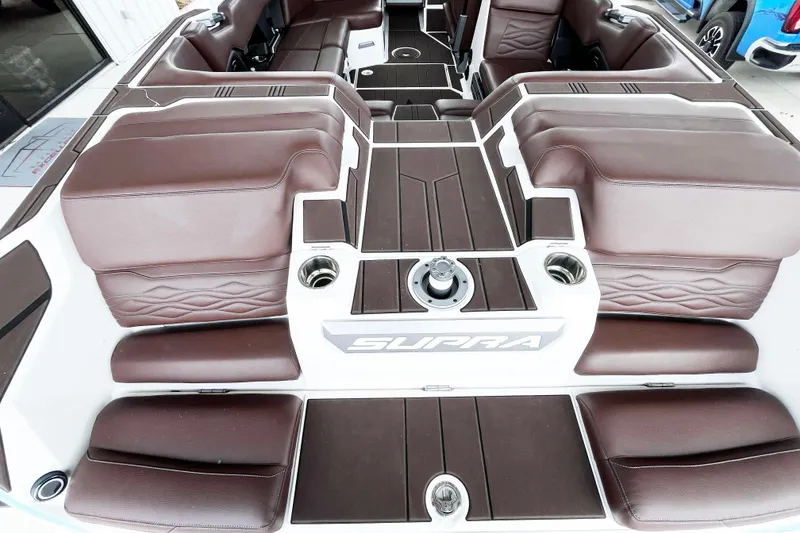 Slide: The Image of 2025 Supra SA450 boat interior with brown leather seating and modern design. - 7