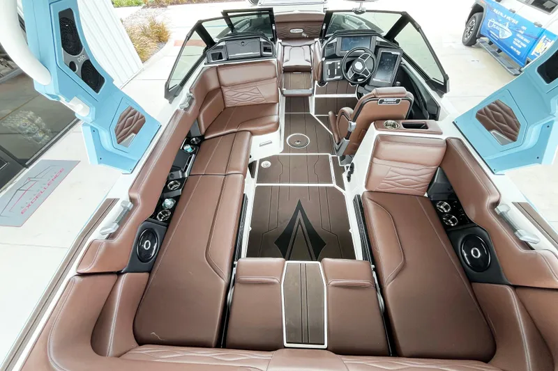 Slide: The Image of Luxurious interior of 2025 Supra SA450 boat with brown seating and modern dashboard. - 8