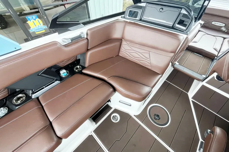 Slide: The Image of 2025 Supra SA450 boat interior with brown leather seating and modern design elements. - 9