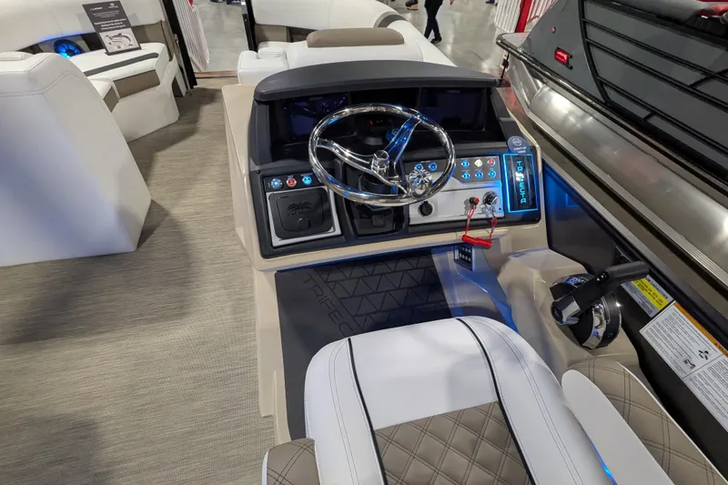 Slide: The Image of 2026 Trifecta 23RFSS boat interior with modern steering console and luxurious seating. - 10