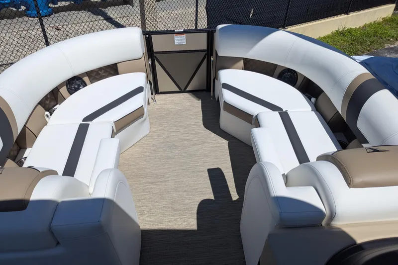 Slide: The Image of Luxurious seating on 2026 Trifecta 23RFSS pontoon boat, featuring elegant white and beige upholstery. - 14
