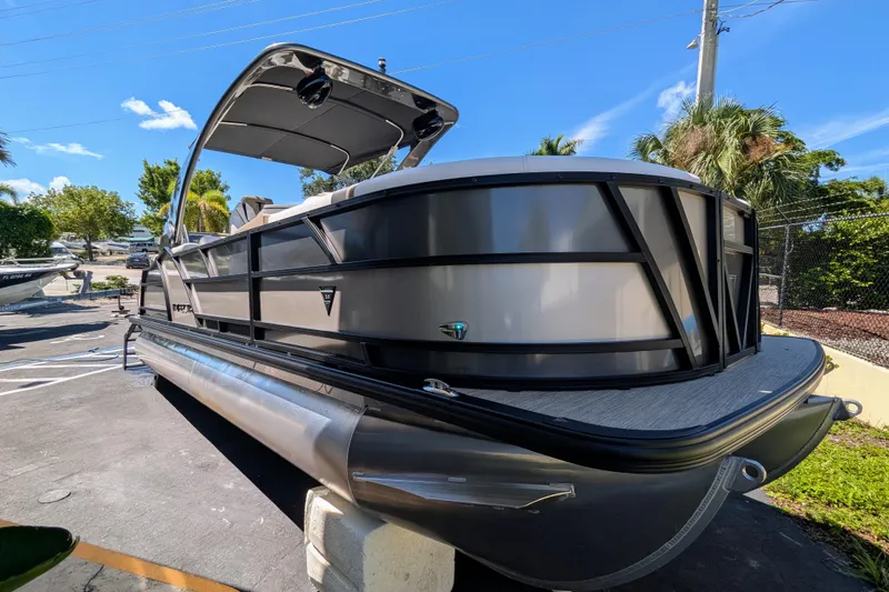 Slide: The Image of 2026 Trifecta 23RFSS pontoon boat parked under clear blue sky. - 2