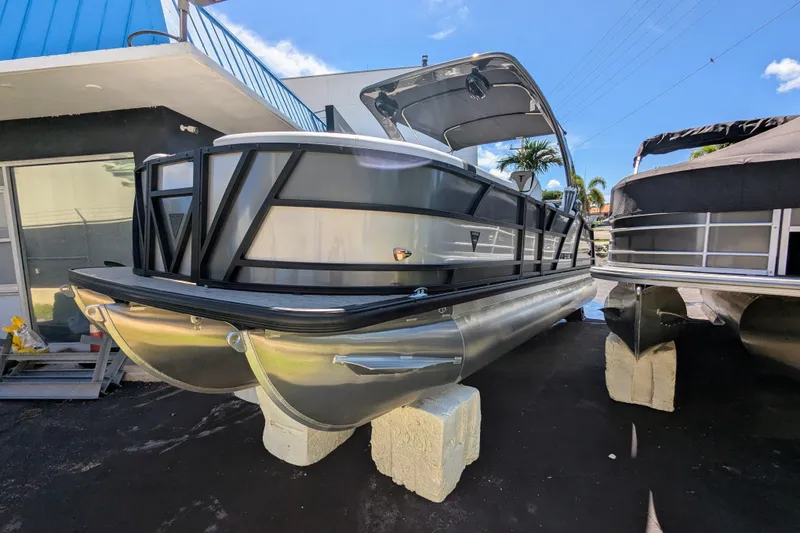 Slide: The Image of 2026 Trifecta 23RFSS pontoon boat displayed outdoors on concrete blocks. - 4