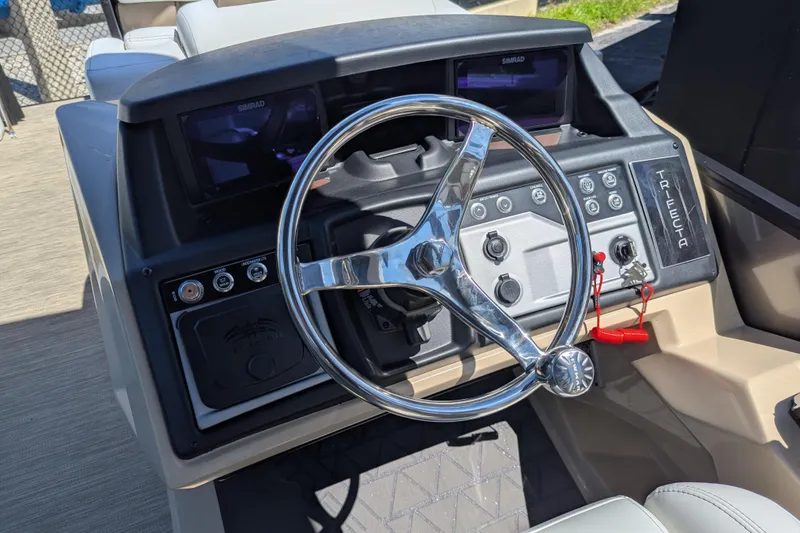 Slide: The Image of 2026 Trifecta 23RFSS boat dashboard with steering wheel and control panel. - 7