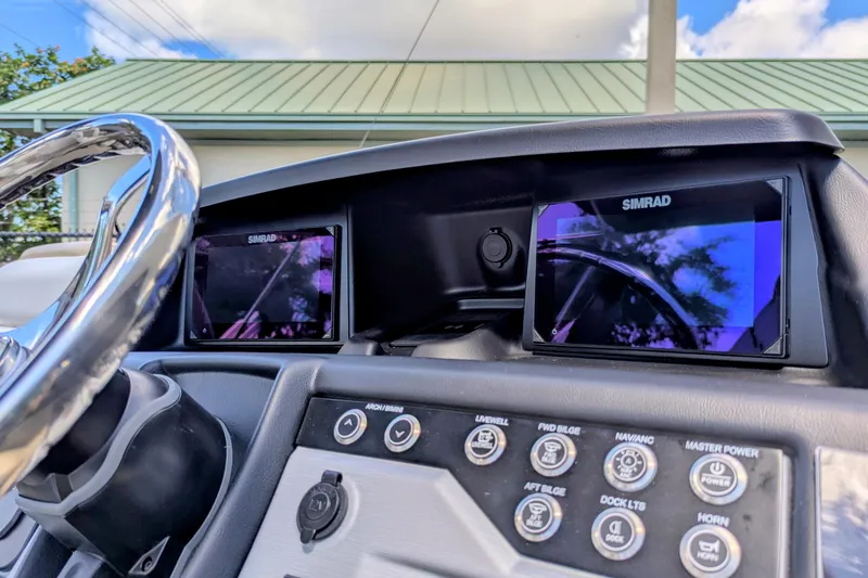 Slide: The Image of Dashboard of 2026 Trifecta 23RFSS boat with dual Simrad displays and control panel. - 8