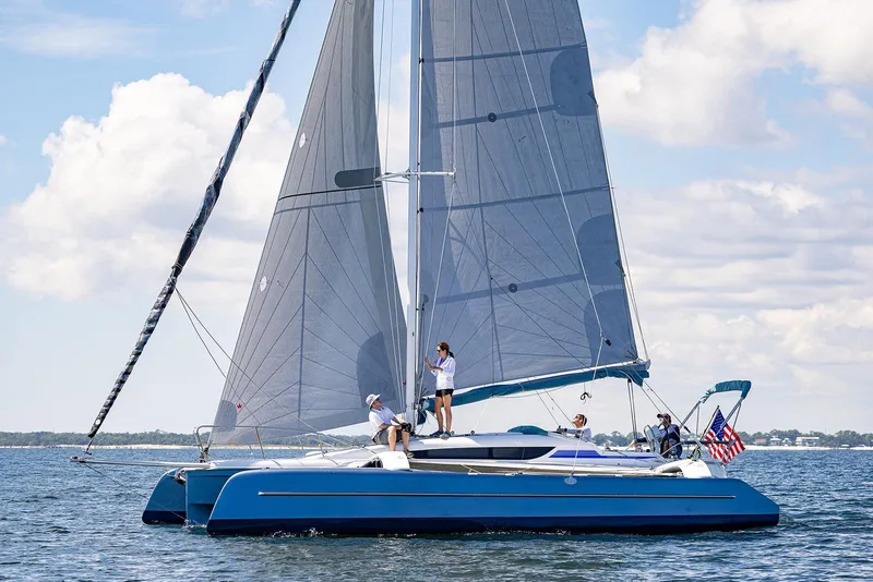 Slide: The Image of Sailing on a Dragonfly 32 Evolution trimaran, 2025 model, under clear skies. - 15