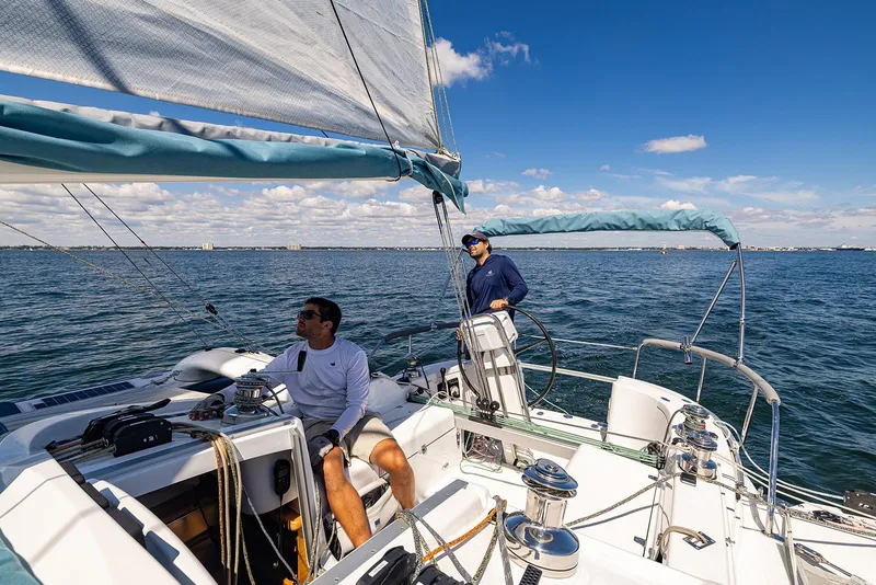 Slide: The Image of Two people sailing on a 2025 Dragonfly 32 Evolution yacht in open waters. - 39