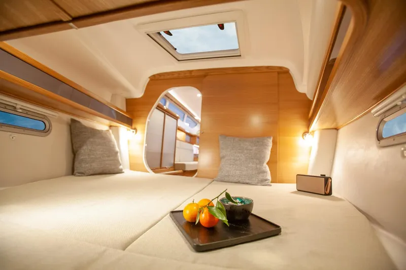 Slide: The Image of Luxurious interior of 2025 Dragonfly 32 Evolution yacht with cozy bedding and natural light. - 45