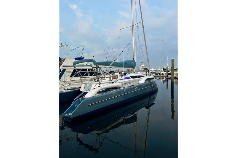Slide: The Image of Sleek 2025 Dragonfly 32 Evolution yacht docked in a serene marina setting. - 50