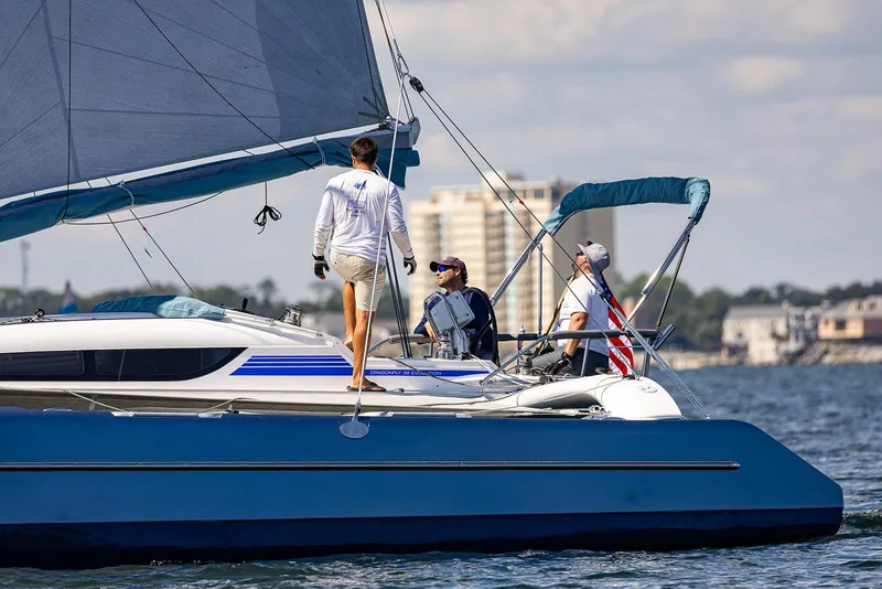 Slide: The Image of Sailors on a 2025 Dragonfly 32 Evolution yacht navigating calm waters. - 9