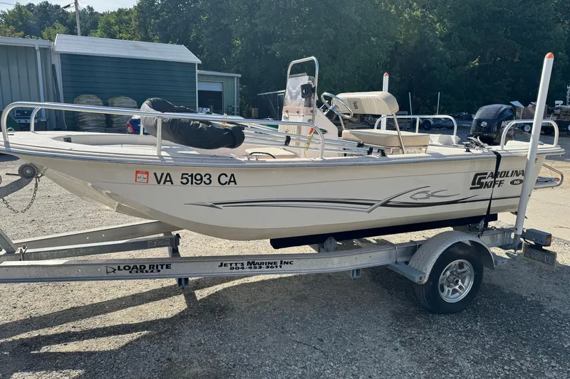 Slide: The Image of 2018 Carolina Skiff 16 JVX CC boat on trailer, parked outdoors. - 0