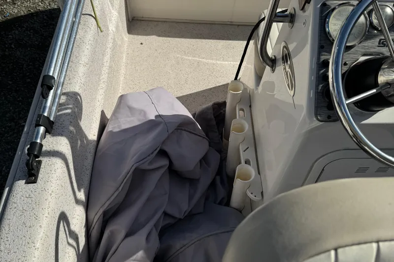 Slide: The Image of 2018 Carolina Skiff 16 JVX CC boat interior with steering wheel and rod holders. - 8