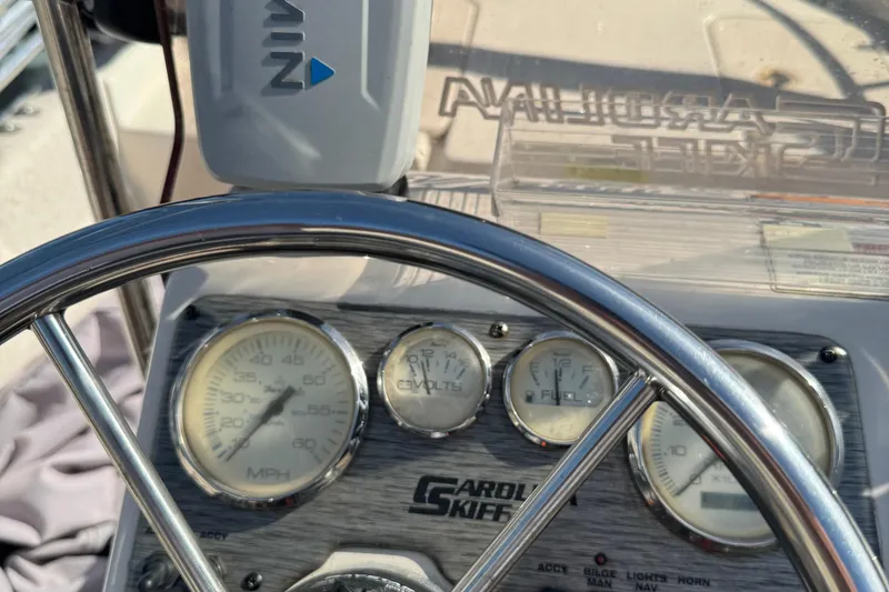 Slide: The Image of 2018 Carolina Skiff 16 JVX CC dashboard with steering wheel and gauges. - 9