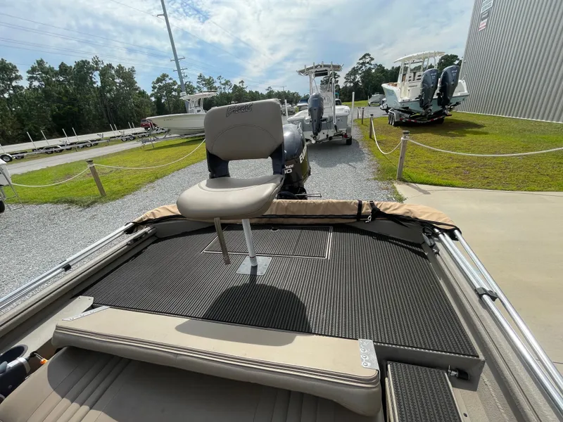 Slide: The Image of 2019 Excel 1860 Stalker SC boat with seating, parked near other boats. - 13