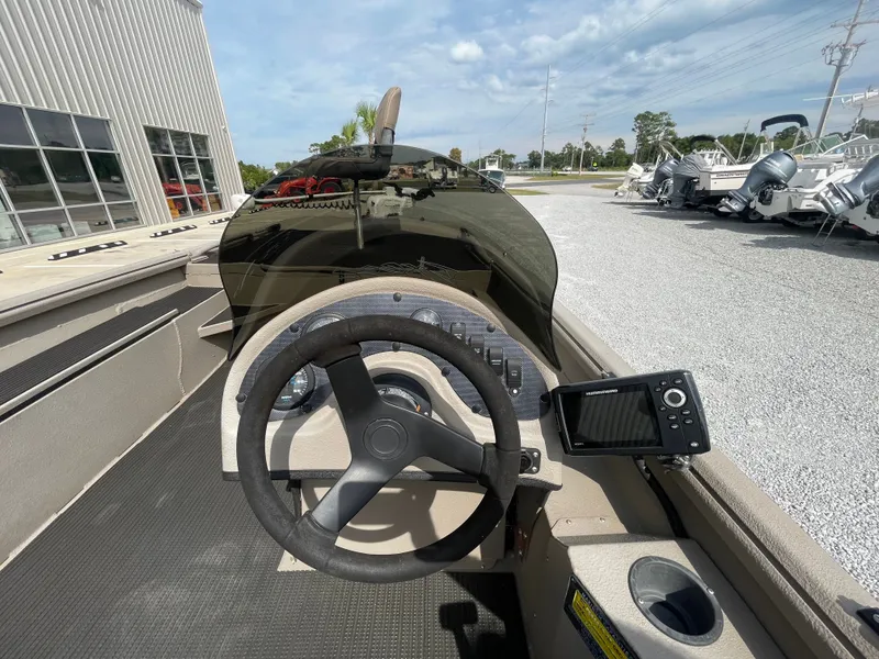 Slide: The Image of 2019 Excel 1860 Stalker SC boat dashboard with steering wheel and navigation system. - 8