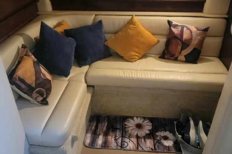 Slide: The Image of Interior of 2007 Sea Ray 440 Sundancer with cozy seating and decorative pillows. - 11