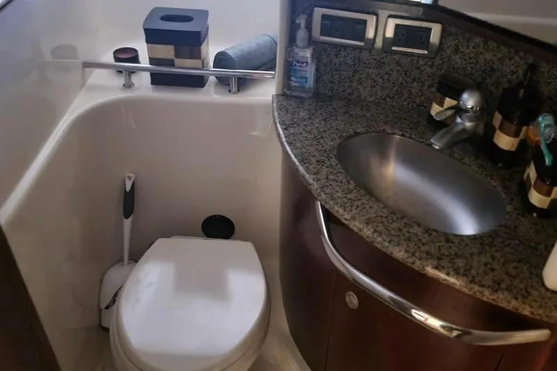 Slide: The Image of 2007 Sea Ray 440 Sundancer bathroom with granite countertop and stainless steel sink. - 12