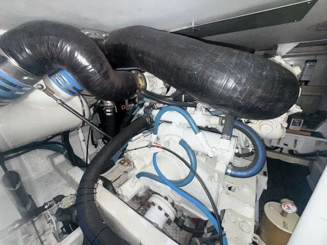 Slide: The Image of Engine room of a 2000 Viking 50 Convertible with hoses and pipes. - 42