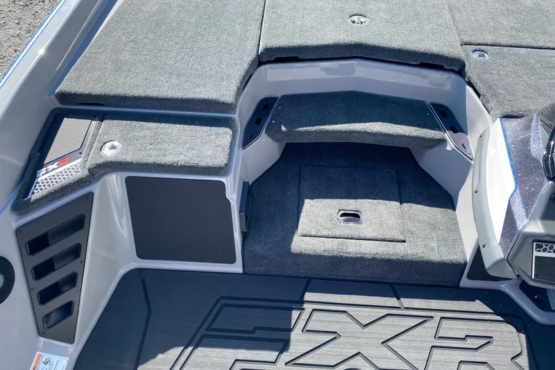 Slide: The Image of 2026 Skeeter FXR21 FLEX boat interior with carpeted storage compartments and sleek design. - 10
