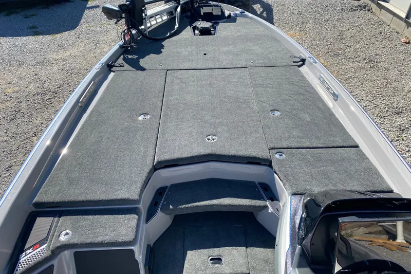 Slide: The Image of 2026 Skeeter FXR21 FLEX boat deck with gray carpeting and advanced controls. - 11