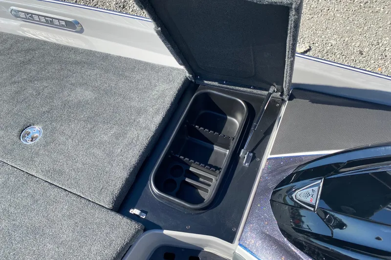 Slide: The Image of 2026 Skeeter FXR21 FLEX boat storage compartment with open lid, showcasing interior design. - 20
